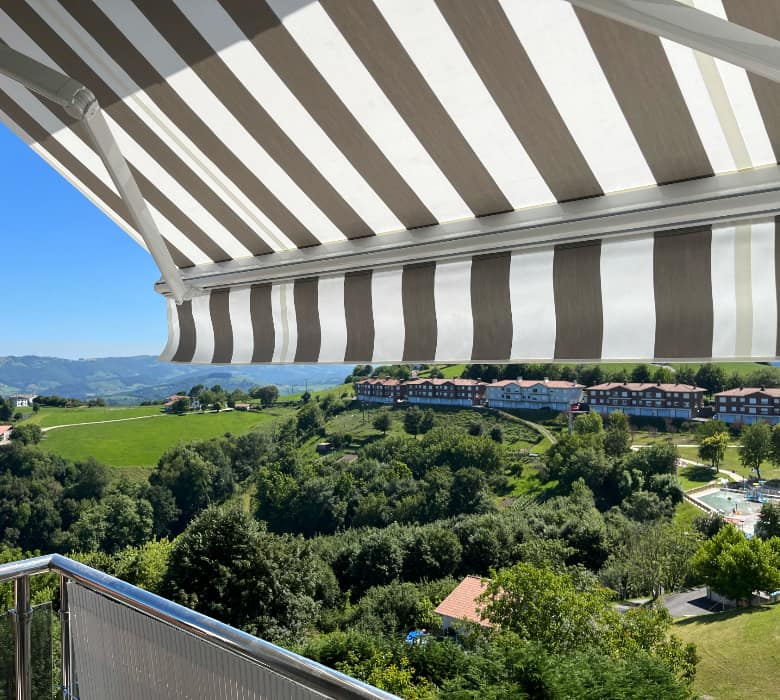 Itzalki Toldoak enpresak Zarautzen (Gipuzkoa, Euskal Herria) instalaturiko marra-dun toldoa balkoi batean, ikuspegi panoramikoekin